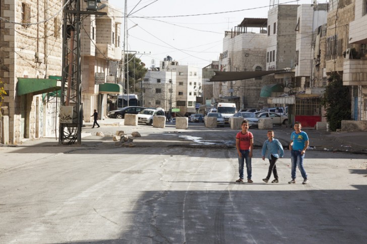 Ahlam Shibli, Untitled (Occupation no. 30), al-Khalil, Palestine, 2016–17, chromogenic print, 100 x 150 cm. Al-Sahleh Street, al-Qaitoun neighborhood, Old Town, al-Khalil, October 20, 2016. The Abu al-Rish checkpoint located in al-Sahleh Street, south of al-Haram al-Ibrahimi (Abraham’s Mosque/Cave of the Patriarchs), is named after the Abu al-Rish mosque and shrine next to it. The checkpoint separates the Abu Sunaina and al-Qaitoun neighborhoods from the neighborhoods of the Old Town. It also separates the neighborhood from the oldest school in al-Khalil, the al-Ibrahimeyeh School, and from al-Hajariya Girls School. Palestinians are allowed to pass only on foot. The infrastructure of the checkpoint was expanded in July 2016, and since it reopened the Israeli Defense Forces (IDF) have prohibited Palestinians between the ages of sixteen and thirty-four from passing. Courtesy of the artist, © Ahlam Shibli